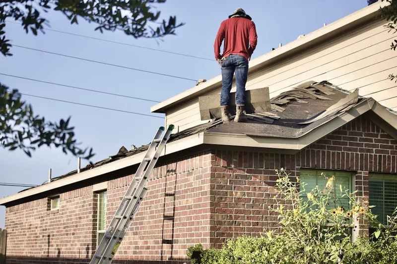 Professional roofer working on a residential roof in Wilmont
